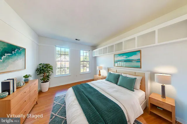 a bedroom with a large bed and a flat screen tv