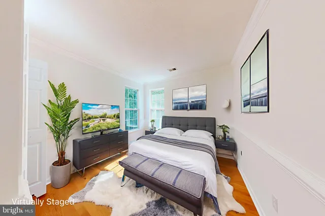 a bed room with a bed window and a potted plant