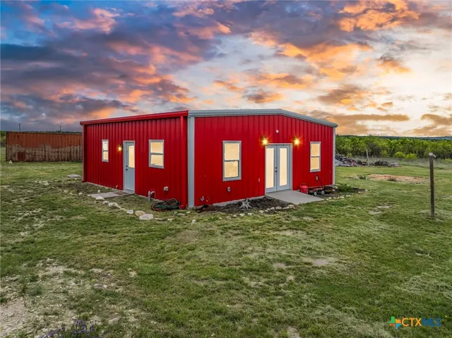 a view of a yard with large trees