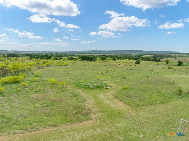 a view of a field with an trees