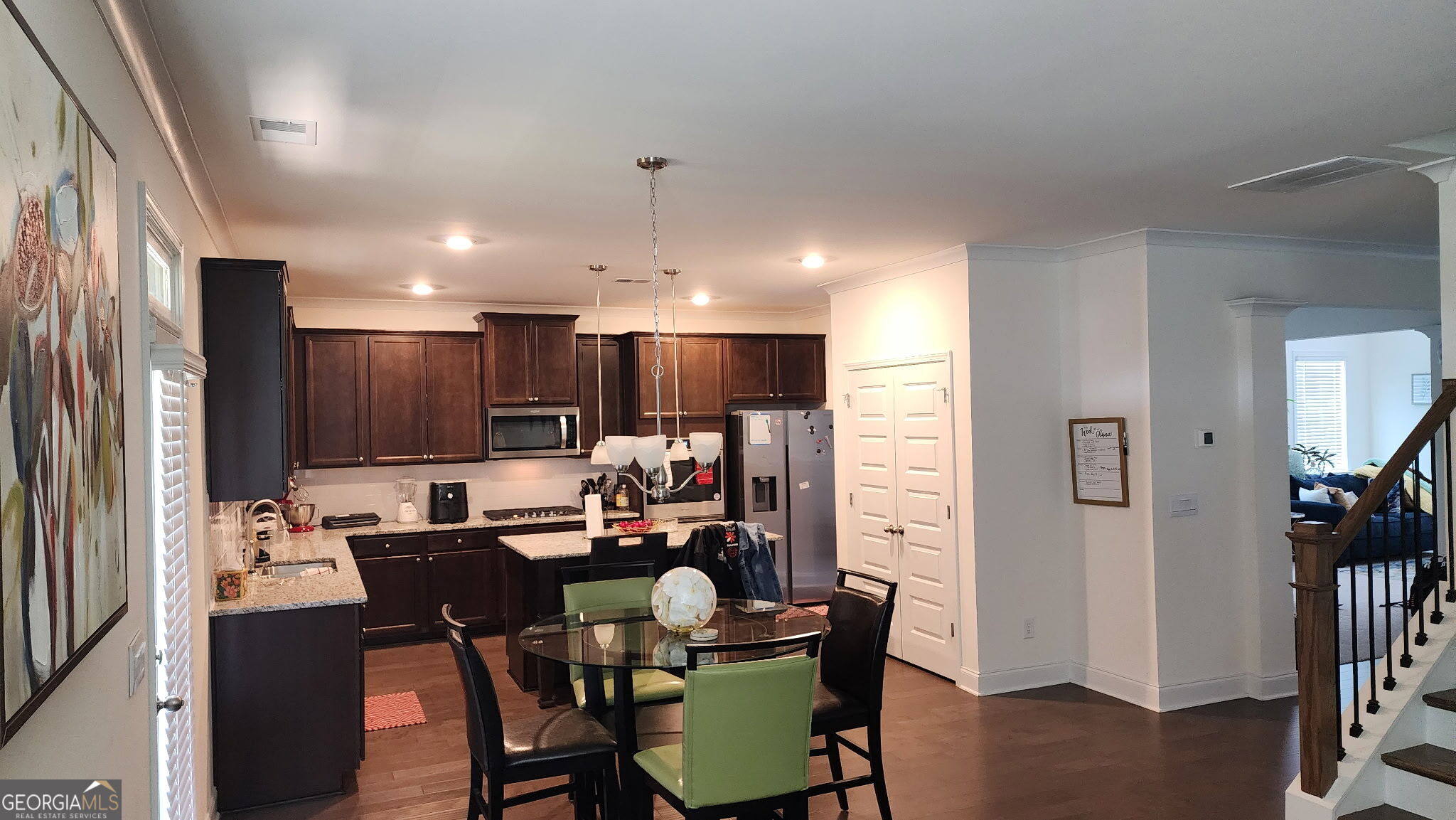 640 Edgar Street Hampton, GA 30228 - Photo 15 of 86 a kitchen with stainless steel appliances a dining table chairs and a refrigerator