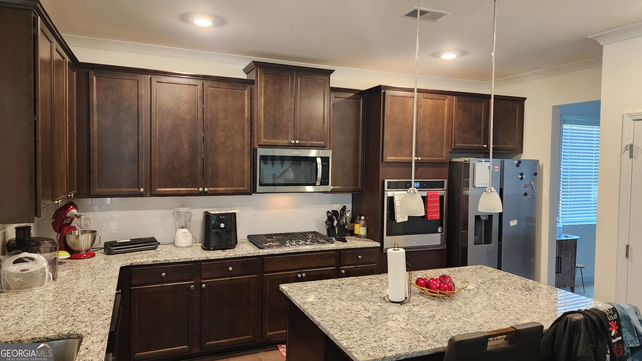 640 Edgar Street Hampton, GA 30228 - Photo 24 of 86 a kitchen with stainless steel appliances granite countertop a sink refrigerator and cabinets