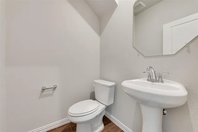 a bathroom with a sink toilet and a mirror