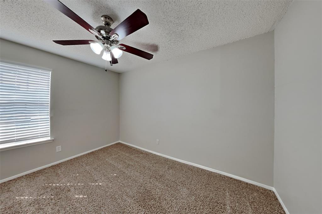6421 Old Mill Circle Watauga, TX 76148 - Photo 12 of 18 an empty room with a window and a fan