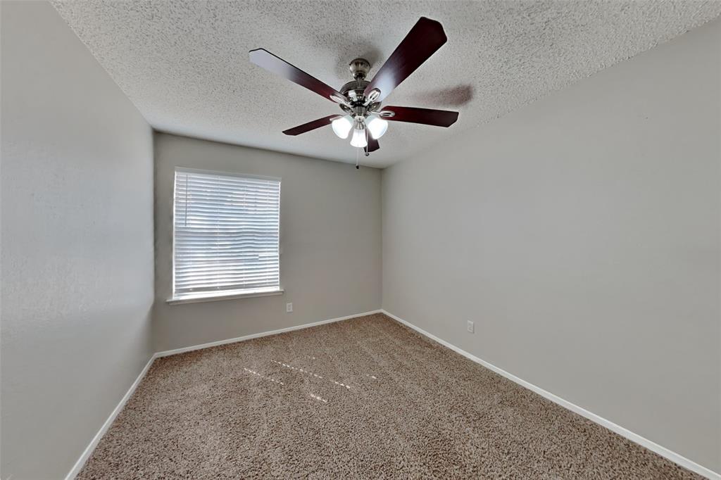 6421 Old Mill Circle Watauga, TX 76148 - Photo 10 of 18 an empty room with window and ceiling fan