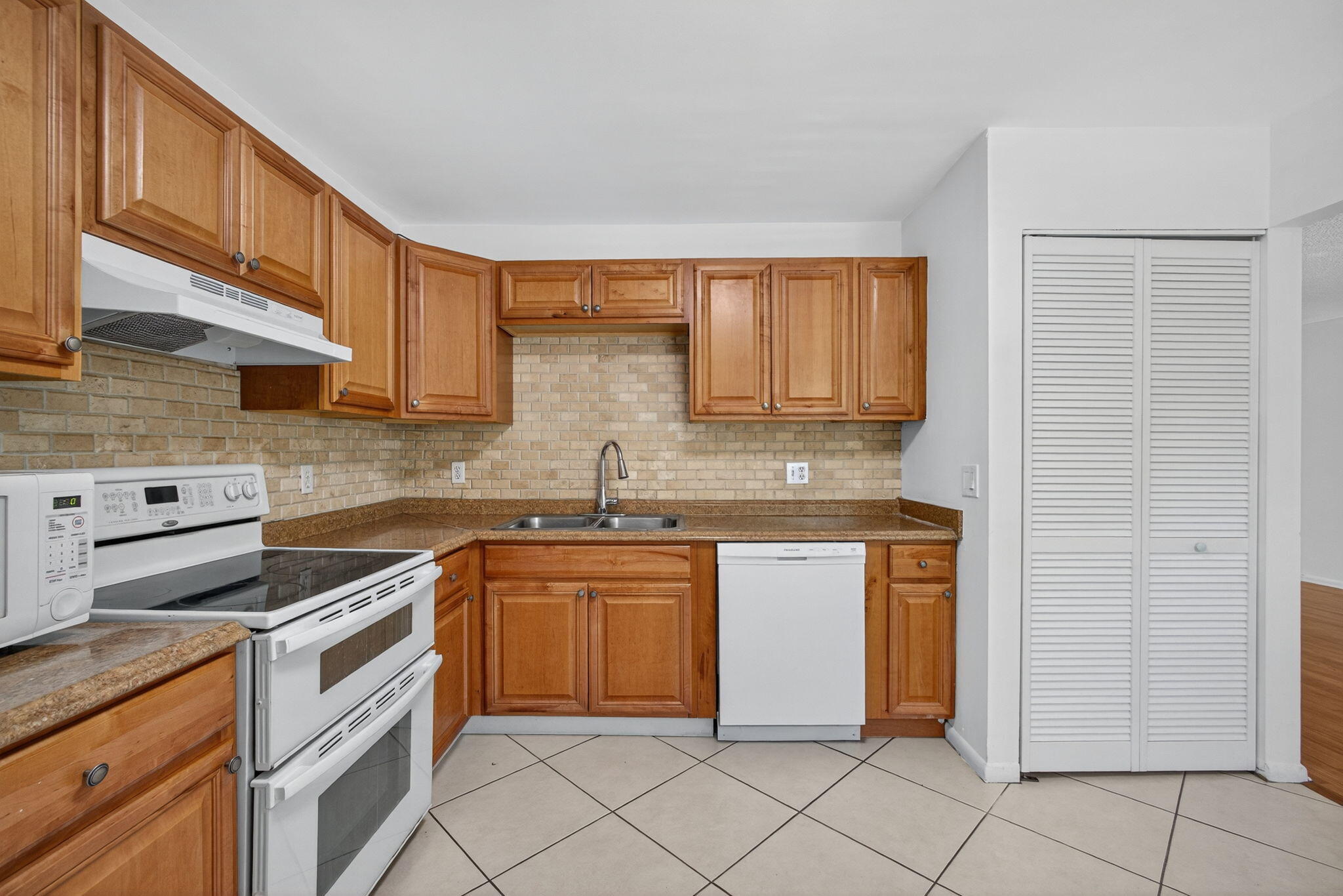 1580 Montauk Drive, Unit 1582 Wellington, FL 33414 - Photo 11 of 28 a kitchen with stainless steel appliances granite countertop a sink stove and cabinets