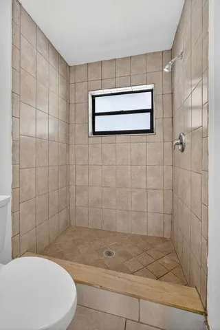 a bathroom with a toilet and shower