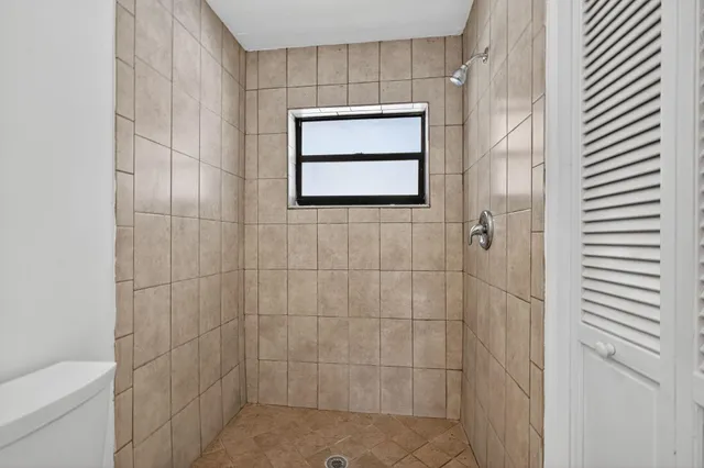 a bathroom with a shower and a toilet