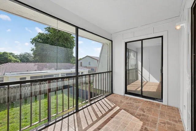 a view of balcony with wooden floor