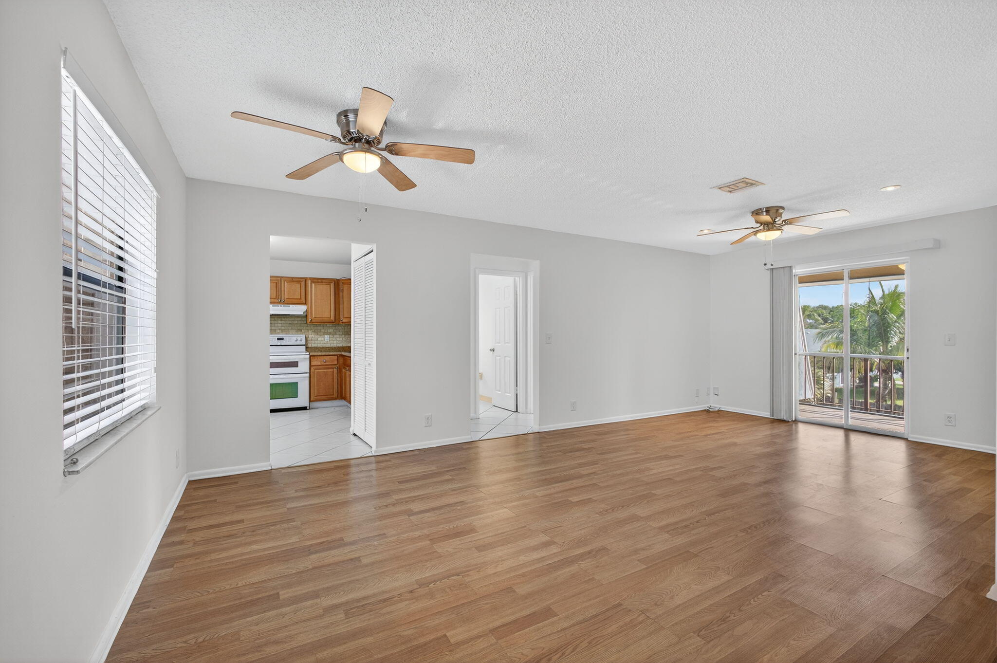 1580 Montauk Drive, Unit 1582 Wellington, FL 33414 - Photo 5 of 28 a view of an empty room with a window and wooden floor