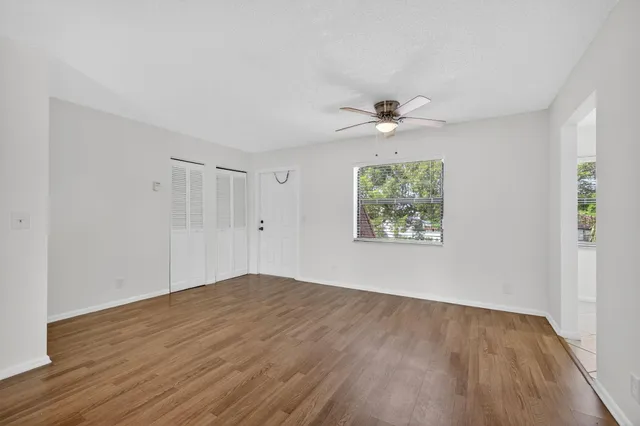 wooden floor in an empty room with a window
