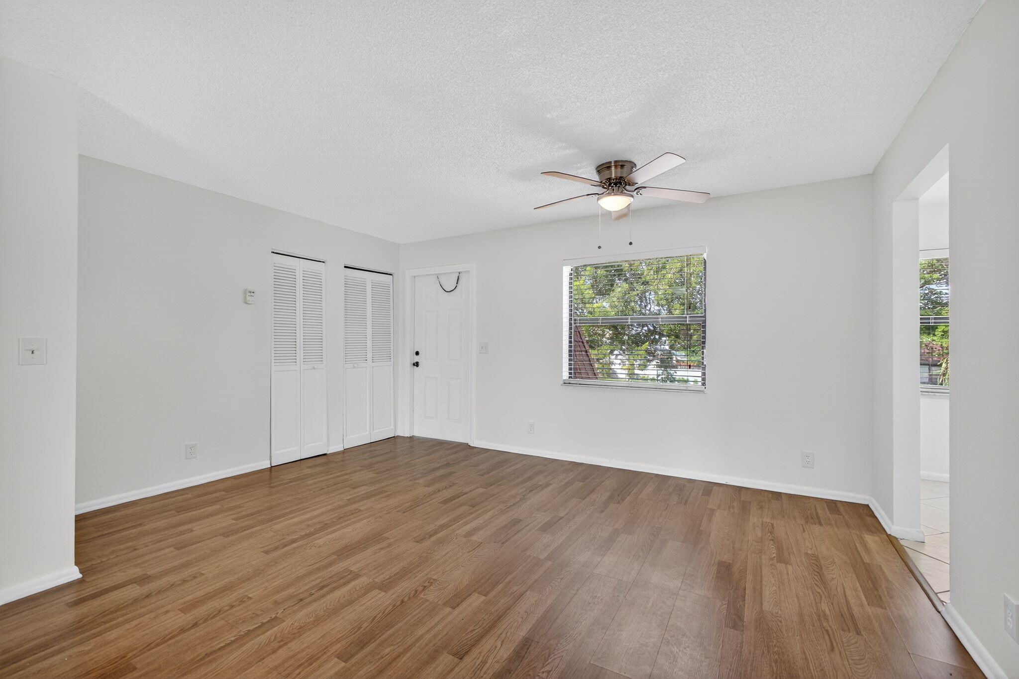 1580 Montauk Drive, Unit 1582 Wellington, FL 33414 - Photo 7 of 28 wooden floor in an empty room with a window