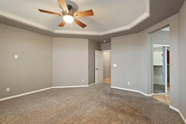 an empty room with closet and fan