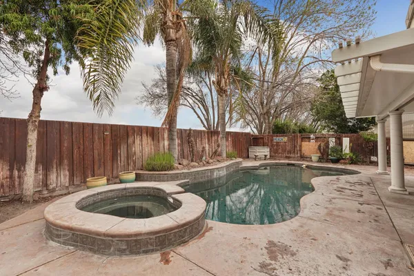 a swimming pool with outdoor seating and yard