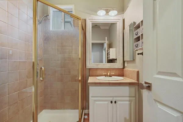 a bathroom with a sink a mirror and a shower