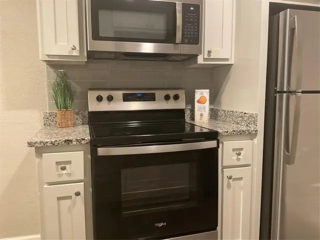 a stove top oven sitting inside of a kitchen