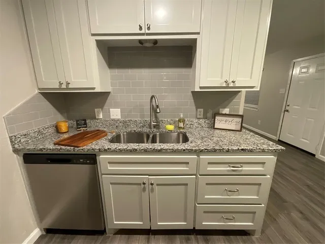 a stove top oven sitting inside of a kitchen
