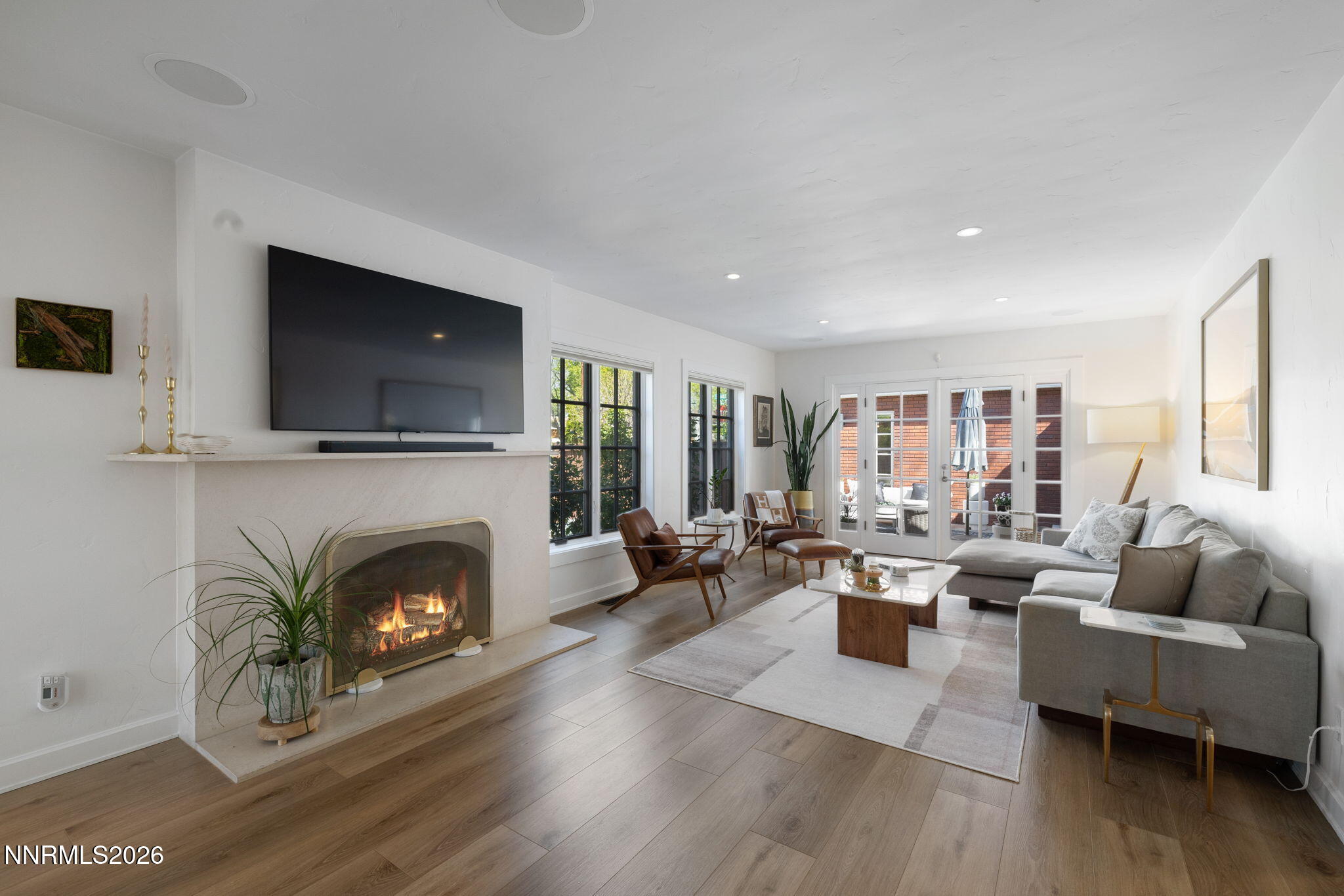 210 Bret Harte Avenue Reno, NV 89509 - Photo 3 of 40 a living room with furniture flat screen tv and a fireplace