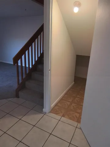 a kitchen with granite countertop white cabinets and window