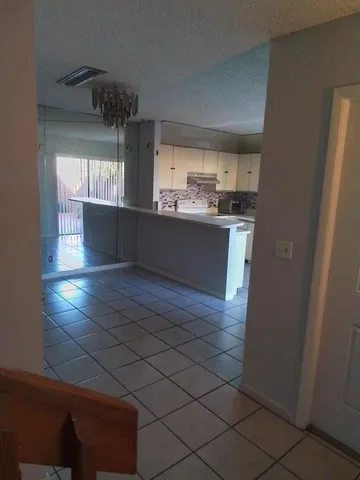 a kitchen with a refrigerator and a stove