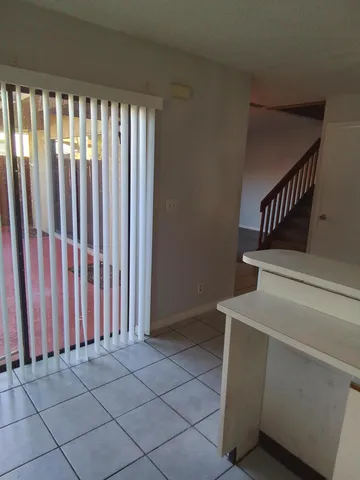 a kitchen with a refrigerator and a stove
