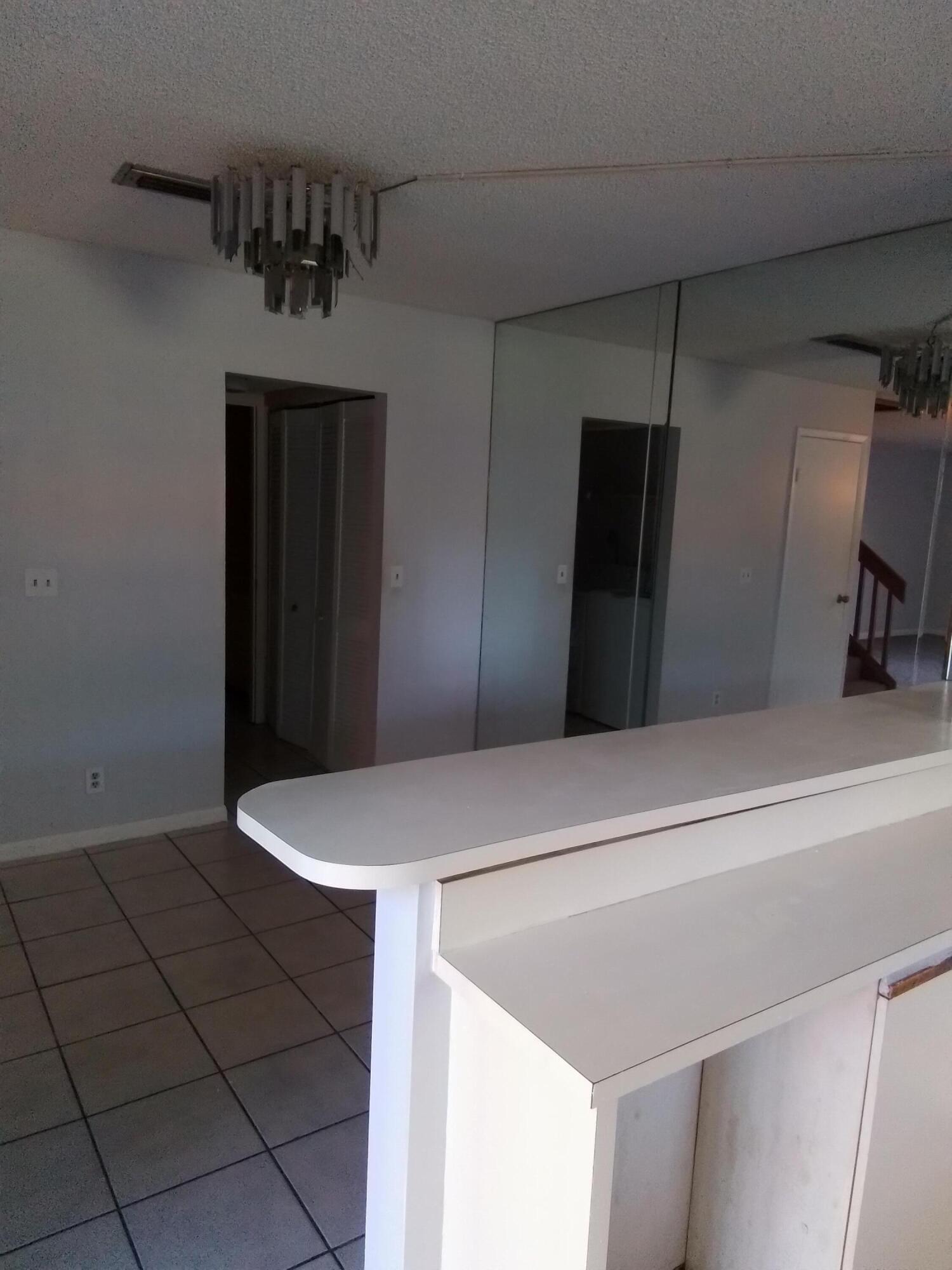 1458 North Lawnwood Circle, Unit 23C Fort Pierce, FL 34950 - Photo 18 of 42 a kitchen with a refrigerator and a stove