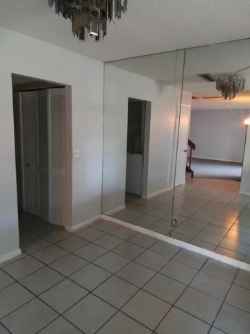 a view of an empty room and wooden floor