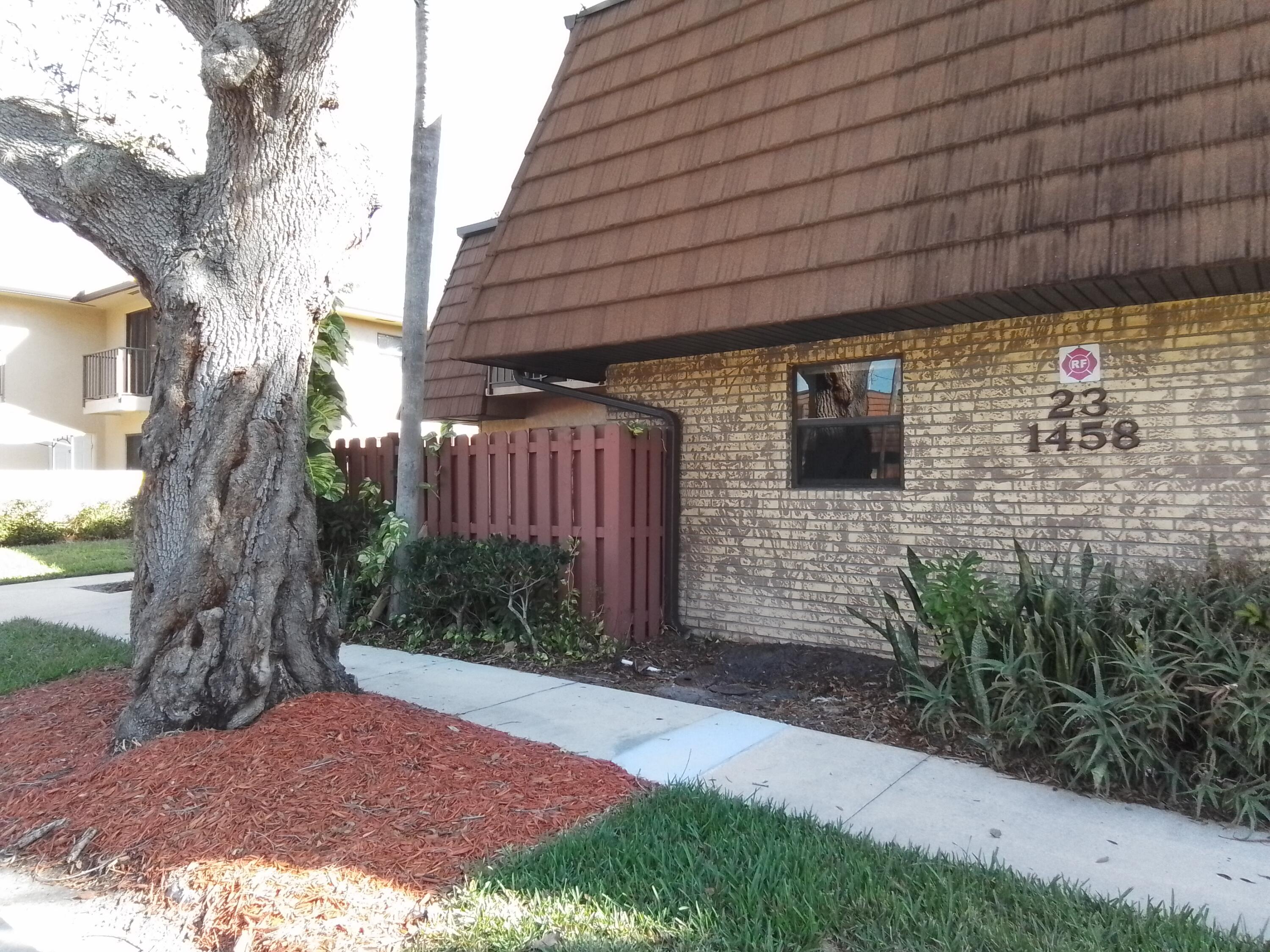 1458 North Lawnwood Circle, Unit 23C Fort Pierce, FL 34950 - Photo 2 of 42 a backyard of a house with lots of green space