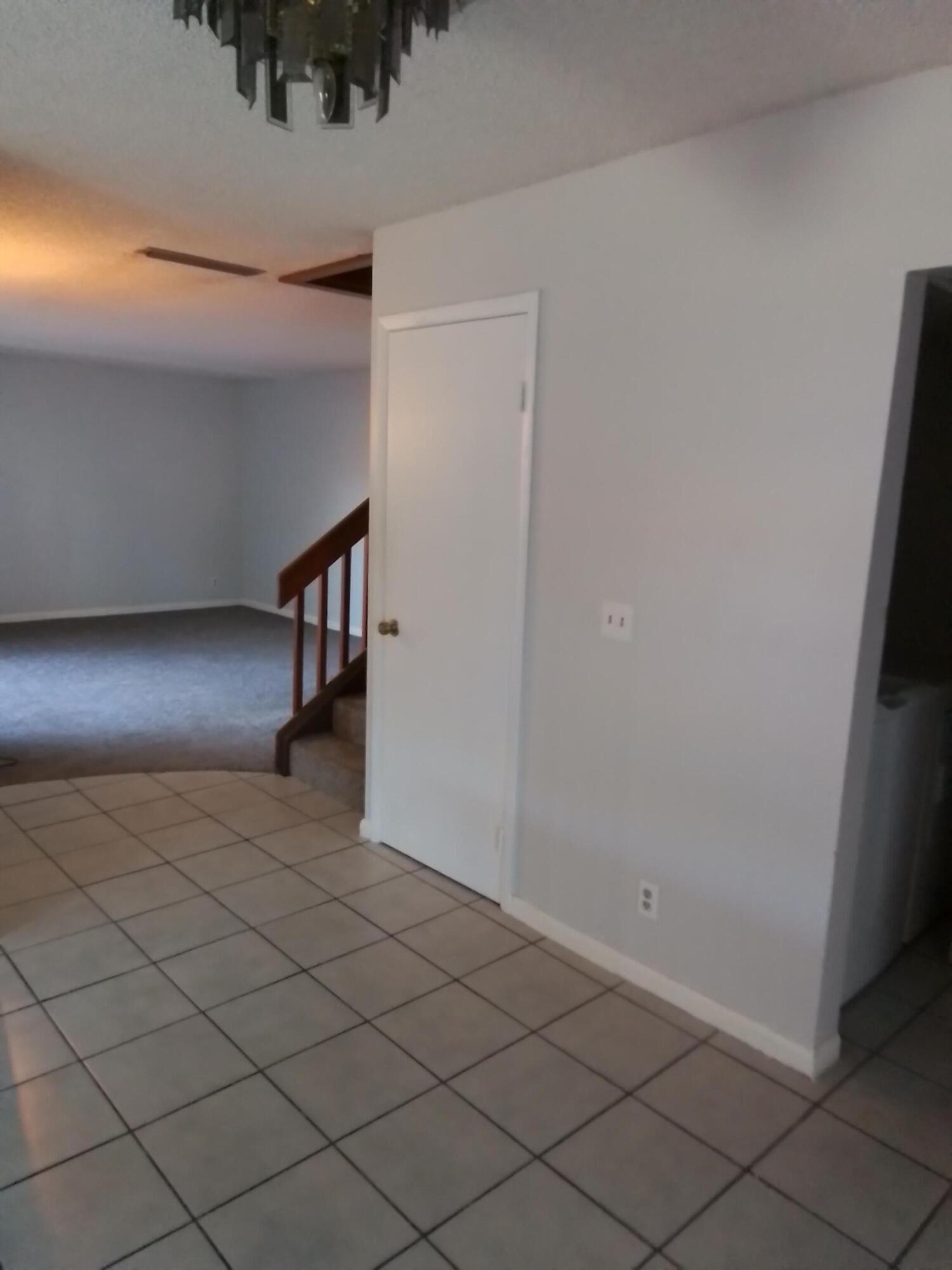 1458 North Lawnwood Circle, Unit 23C Fort Pierce, FL 34950 - Photo 21 of 42 a view of an empty room and wooden floor