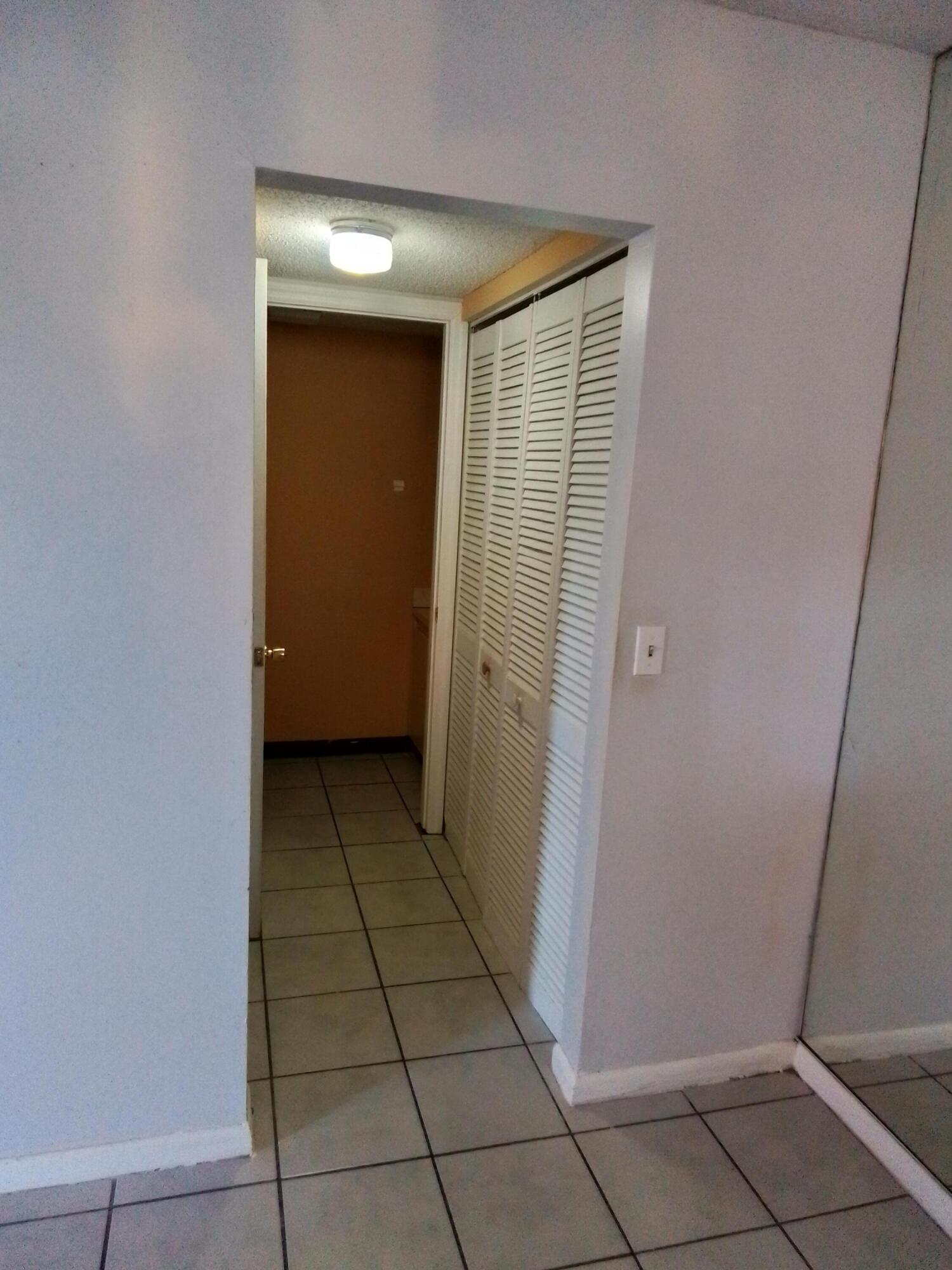 1458 North Lawnwood Circle, Unit 23C Fort Pierce, FL 34950 - Photo 22 of 42 a view of entryway with white walls and tiles