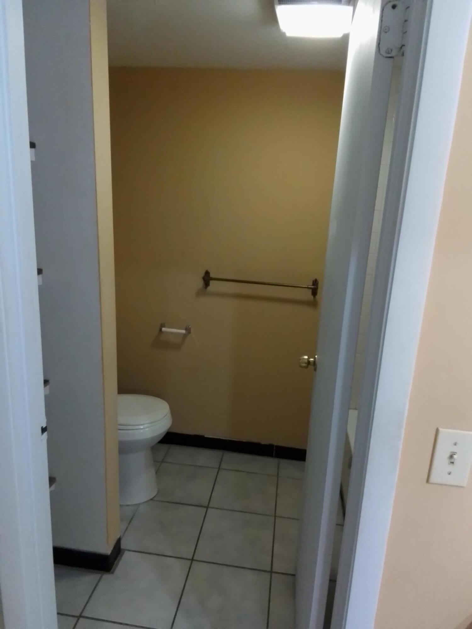 1458 North Lawnwood Circle, Unit 23C Fort Pierce, FL 34950 - Photo 25 of 42 a bathroom with a toilet