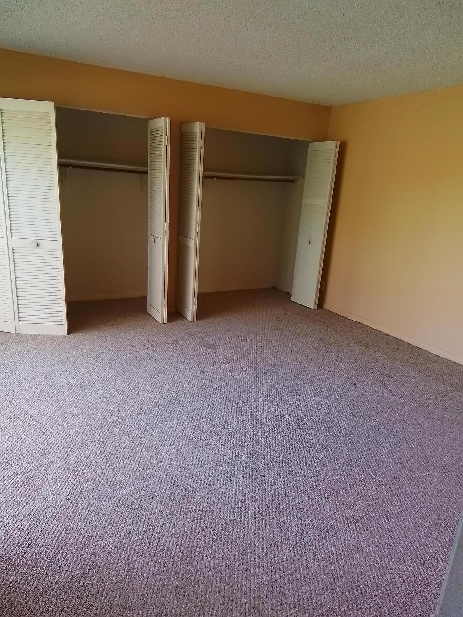 1458 North Lawnwood Circle, Unit 23C Fort Pierce, FL 34950 - Photo 28 of 42 a view of empty room with closet