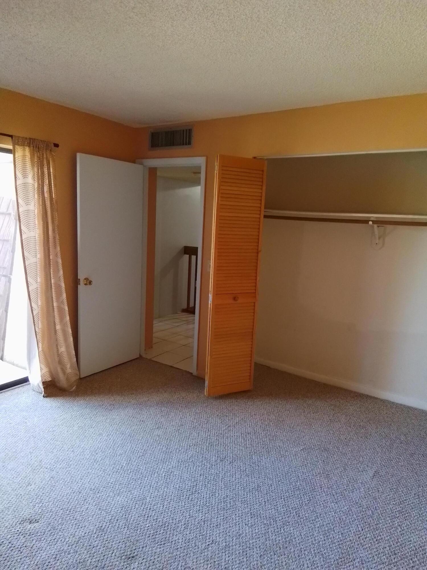 1458 North Lawnwood Circle, Unit 23C Fort Pierce, FL 34950 - Photo 29 of 42 an empty room with closet