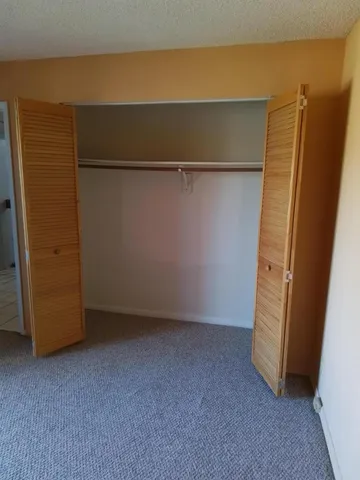 a view of an empty room and wooden floor