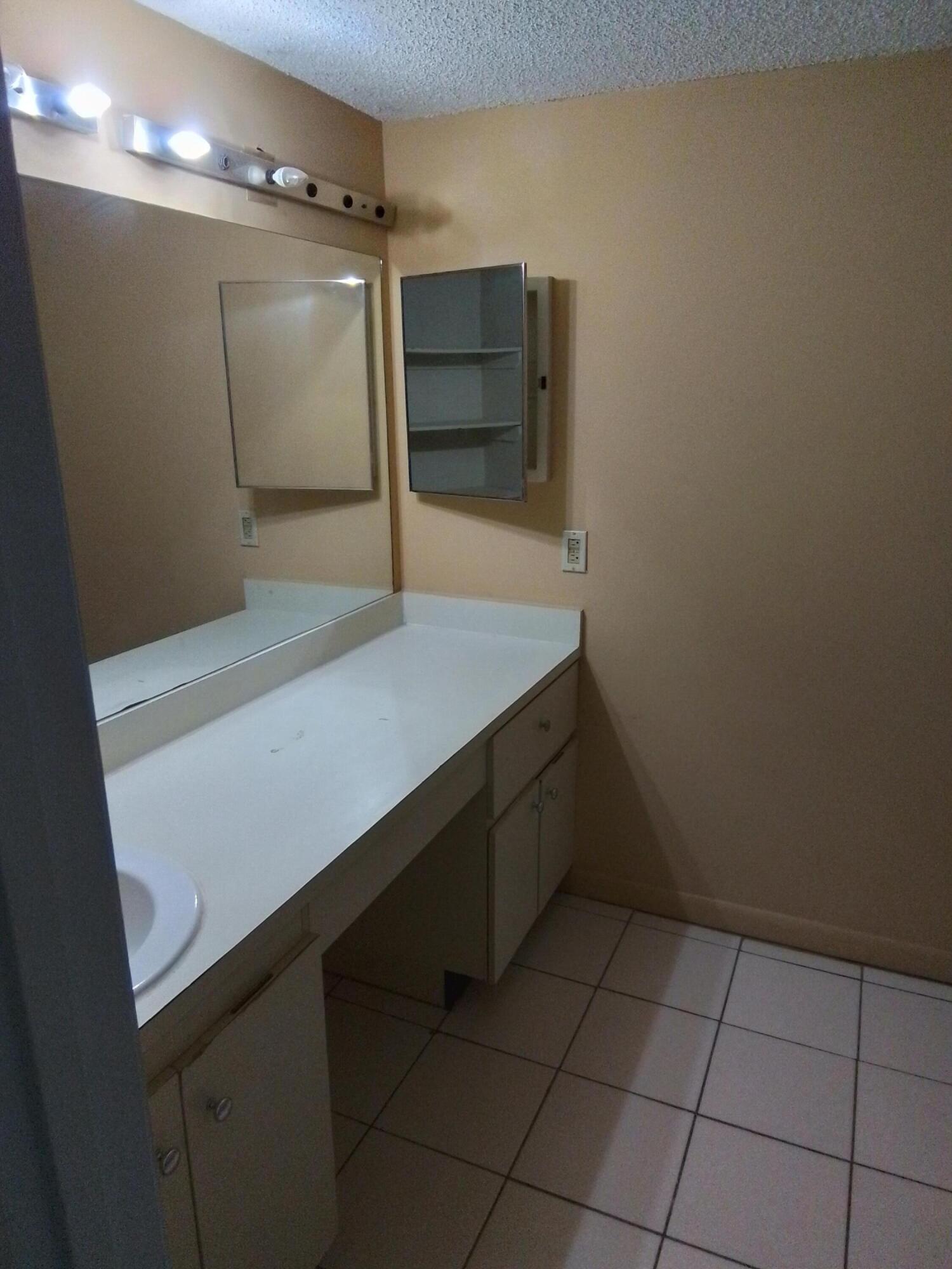 1458 North Lawnwood Circle, Unit 23C Fort Pierce, FL 34950 - Photo 36 of 42 a room with cabinets