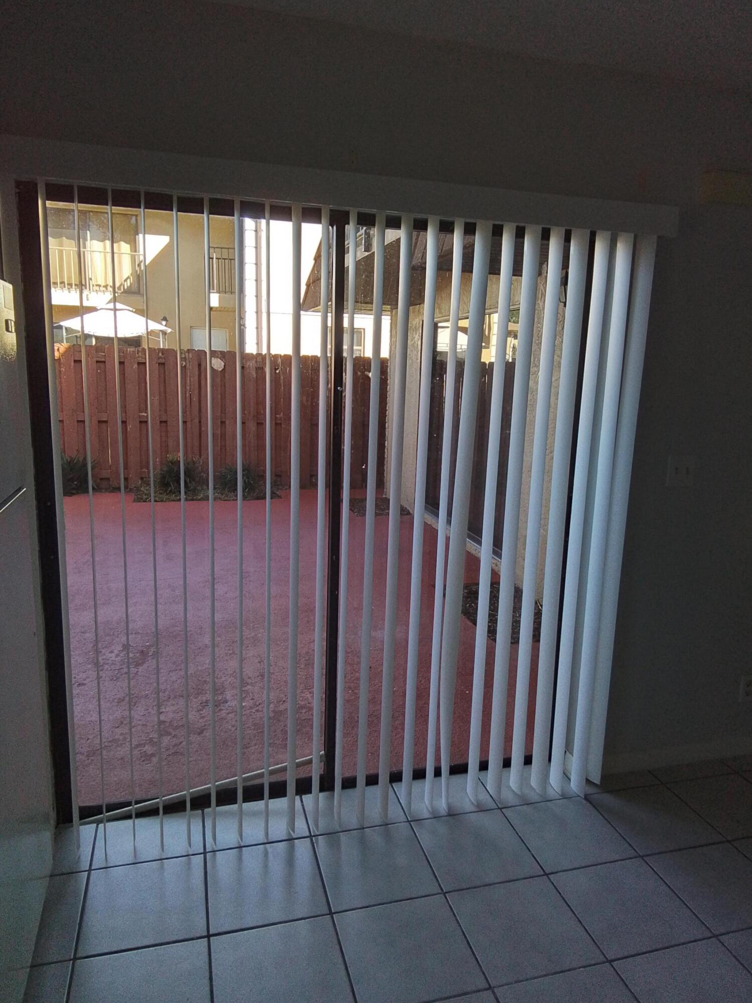 1458 North Lawnwood Circle, Unit 23C Fort Pierce, FL 34950 - Photo 9 of 42 a view of a black gate