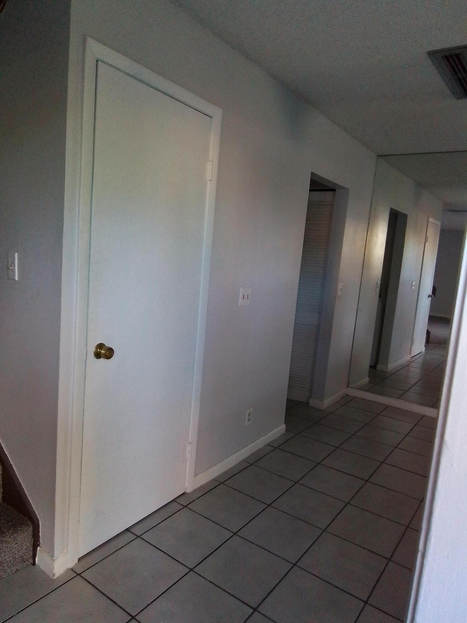 1458 North Lawnwood Circle, Unit 23C Fort Pierce, FL 34950 - Photo 10 of 42 a view of a hallway