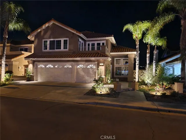a front view of a house with a yard garage and outdoor seating