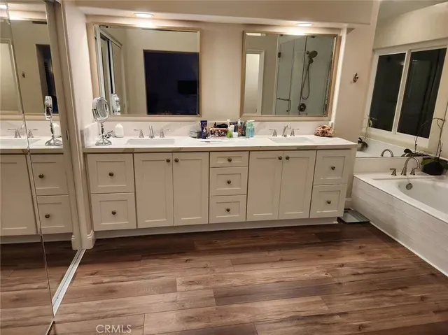 a bathroom with a sink double vanity granite and a mirror
