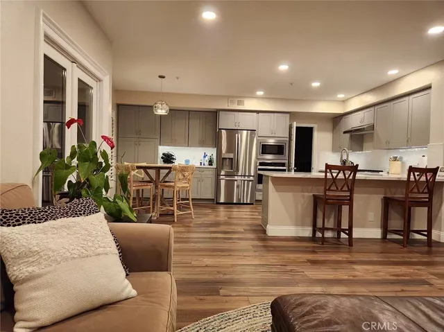 a living room with fireplace furniture and a wooden floor