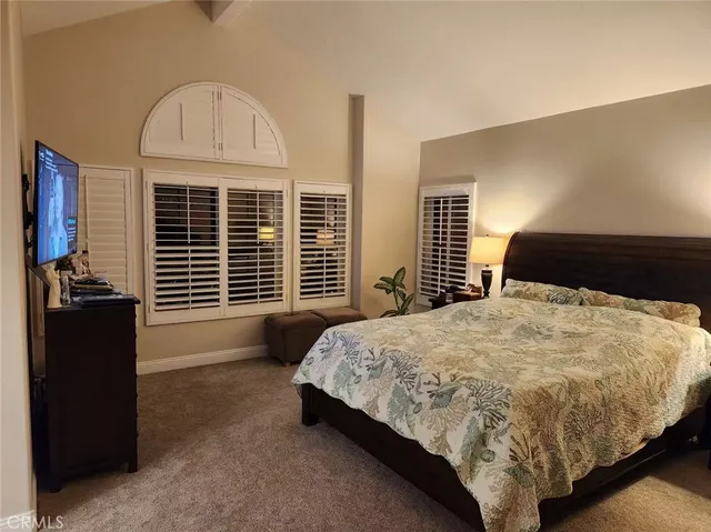 a bed sitting in a bedroom next to a window