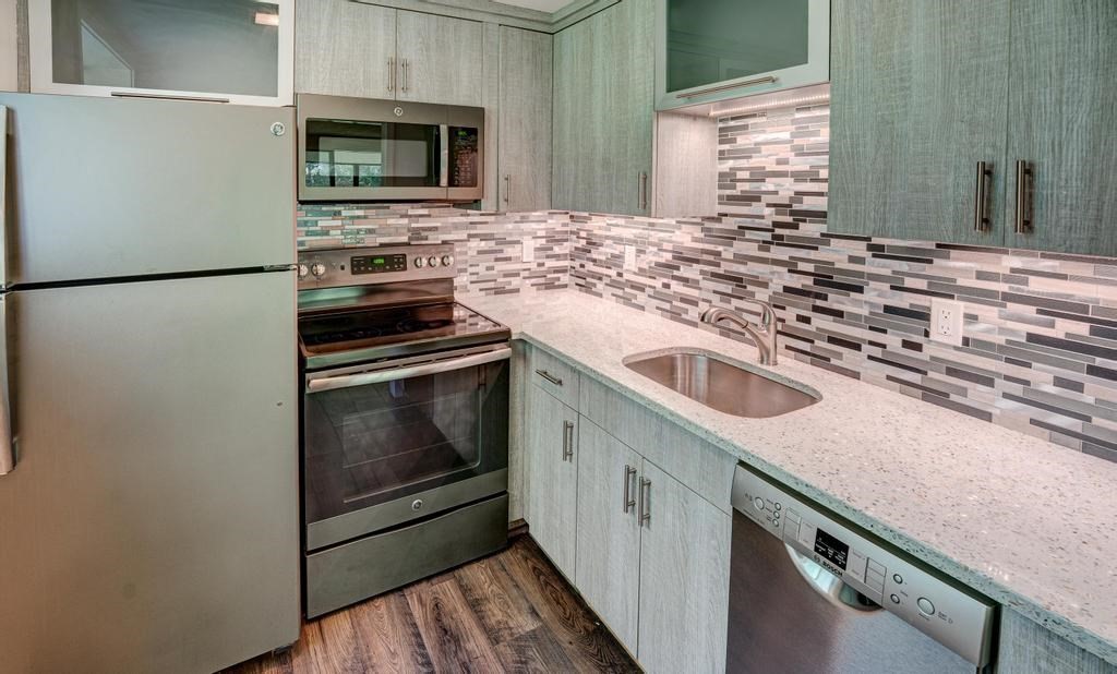 376 Great Road, Unit 15 Acton, MA 01720 - Photo 14 of 27 a kitchen with granite countertop a sink stove and refrigerator