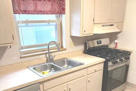 a kitchen with a sink and a window
