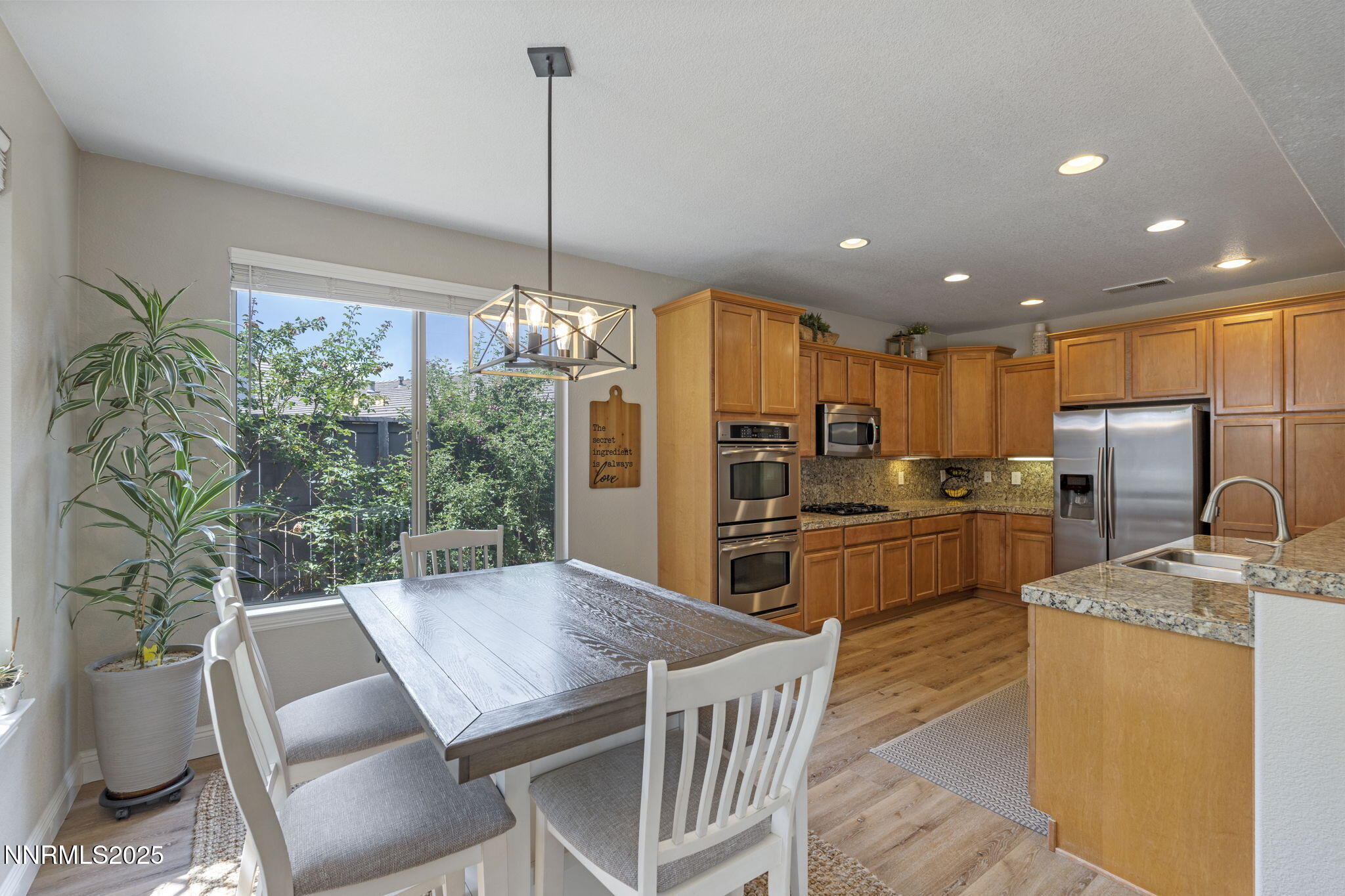 640 Preakness Court Reno, NV 89521 - Photo 22 of 59 a kitchen with sink refrigerator dining table and chairs