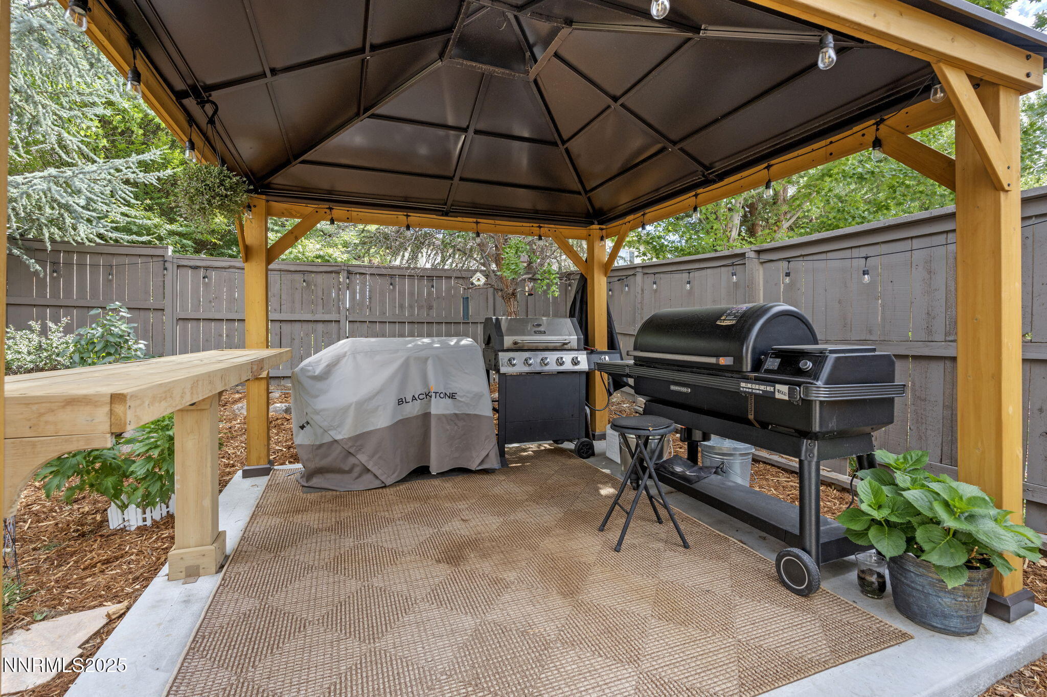 640 Preakness Court Reno, NV 89521 - Photo 50 of 59 a view of a roof deck with table and chairs under an umbrella