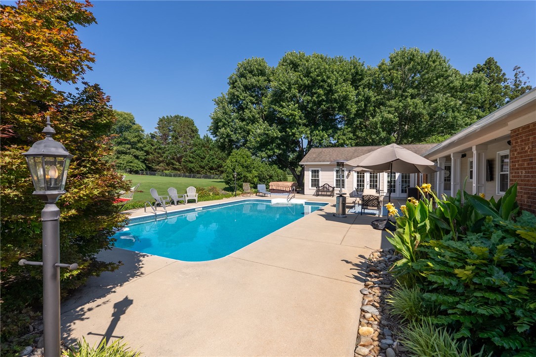 3513 Hopewell Road Anderson, SC 29621 - Photo 33 of 50 An inviting backyard oasis awaits with a sparkling pool and ample patio space for outdoor enjoyment.