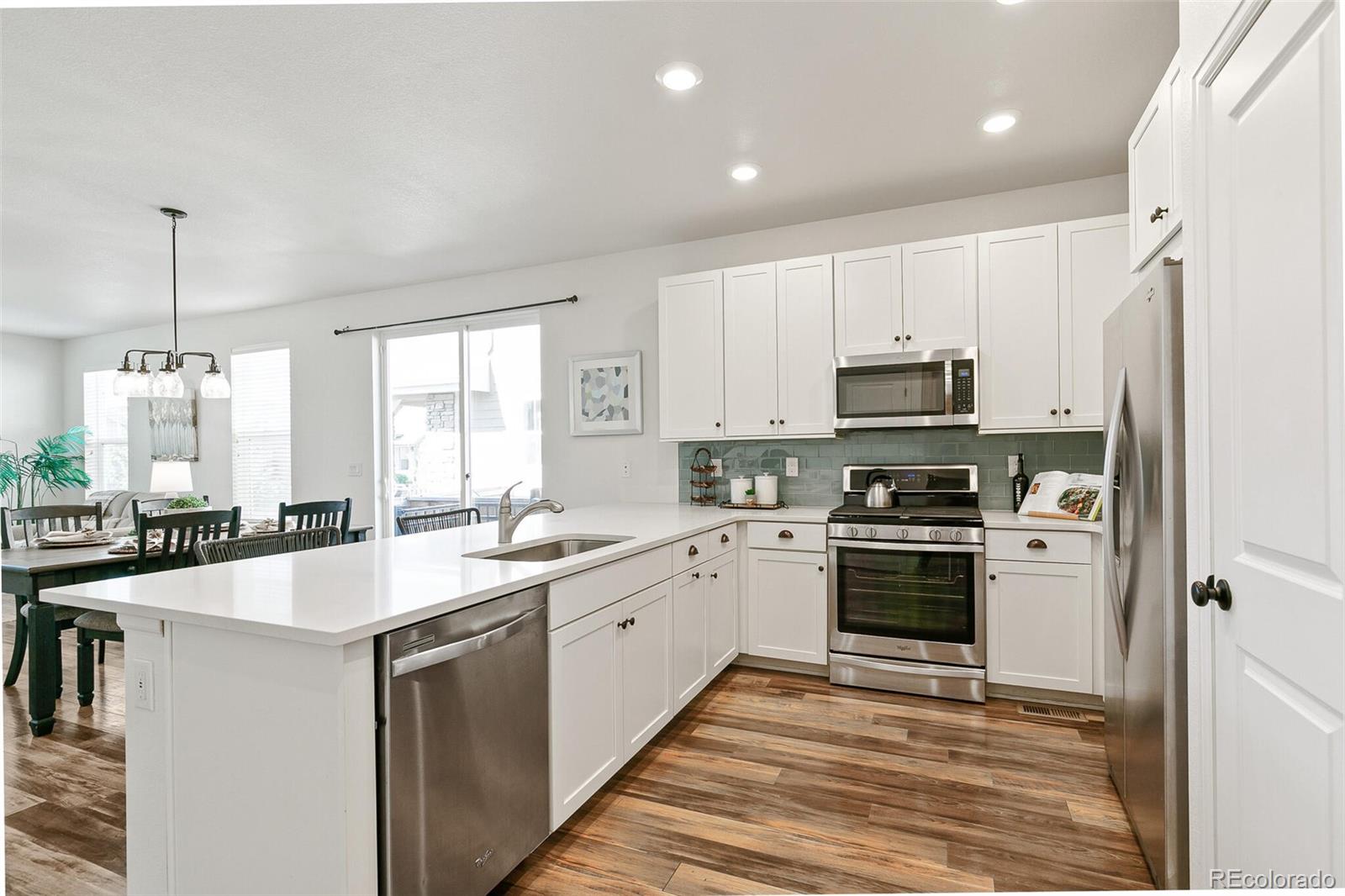 11159 East 25th Drive Aurora, CO 80010 - Photo 11 of 23 a kitchen with stainless steel appliances a sink stove and refrigerator