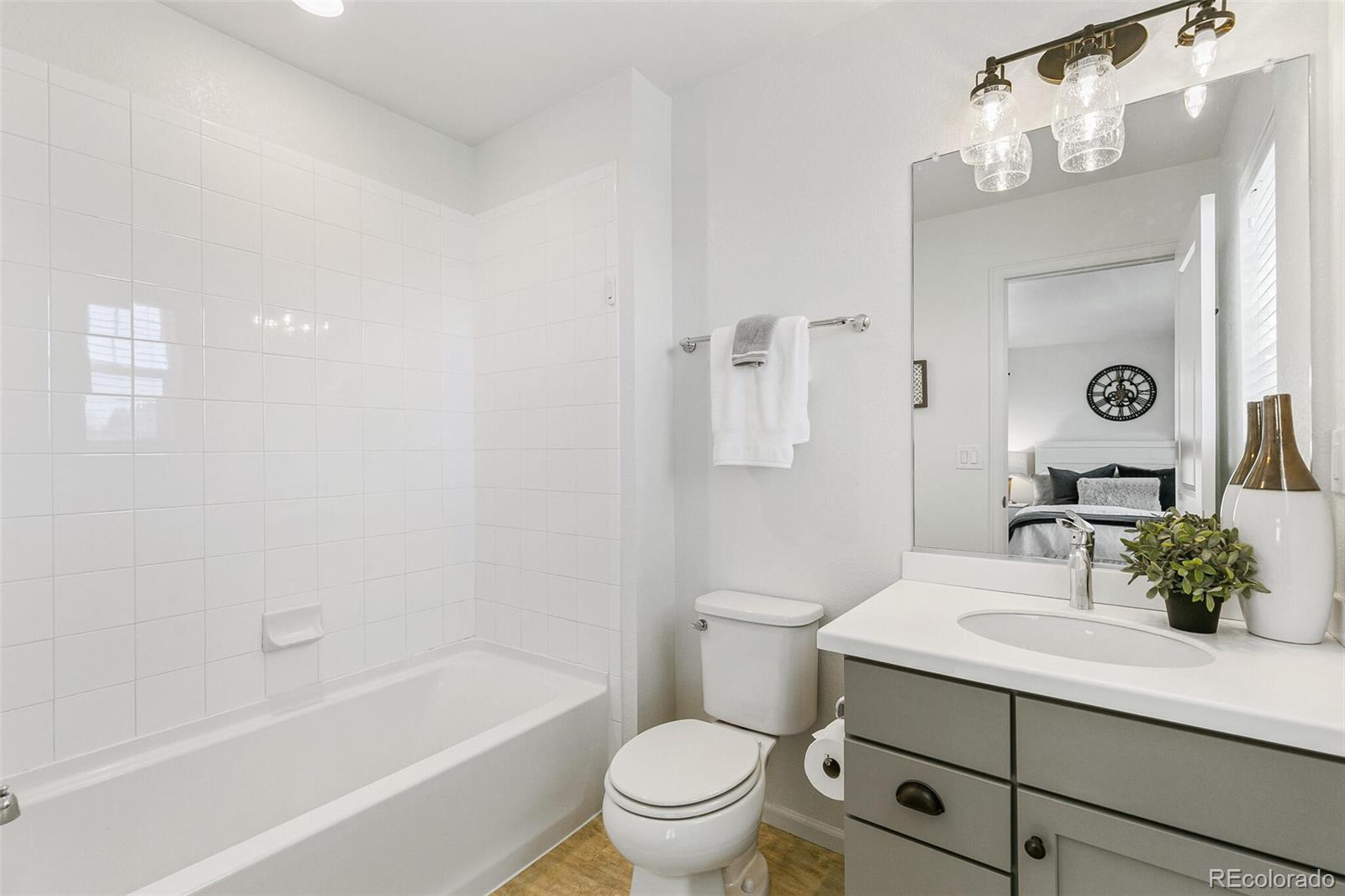 11159 East 25th Drive Aurora, CO 80010 - Photo 16 of 23 a bathroom with a sink a toilet and shower