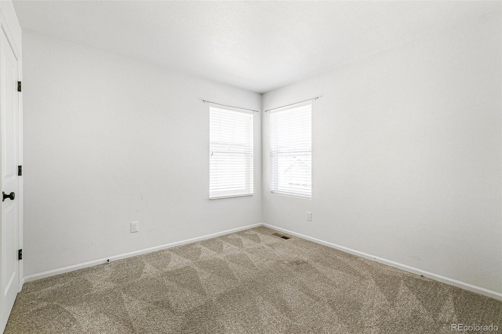 11159 East 25th Drive Aurora, CO 80010 - Photo 18 of 23 an empty room with windows