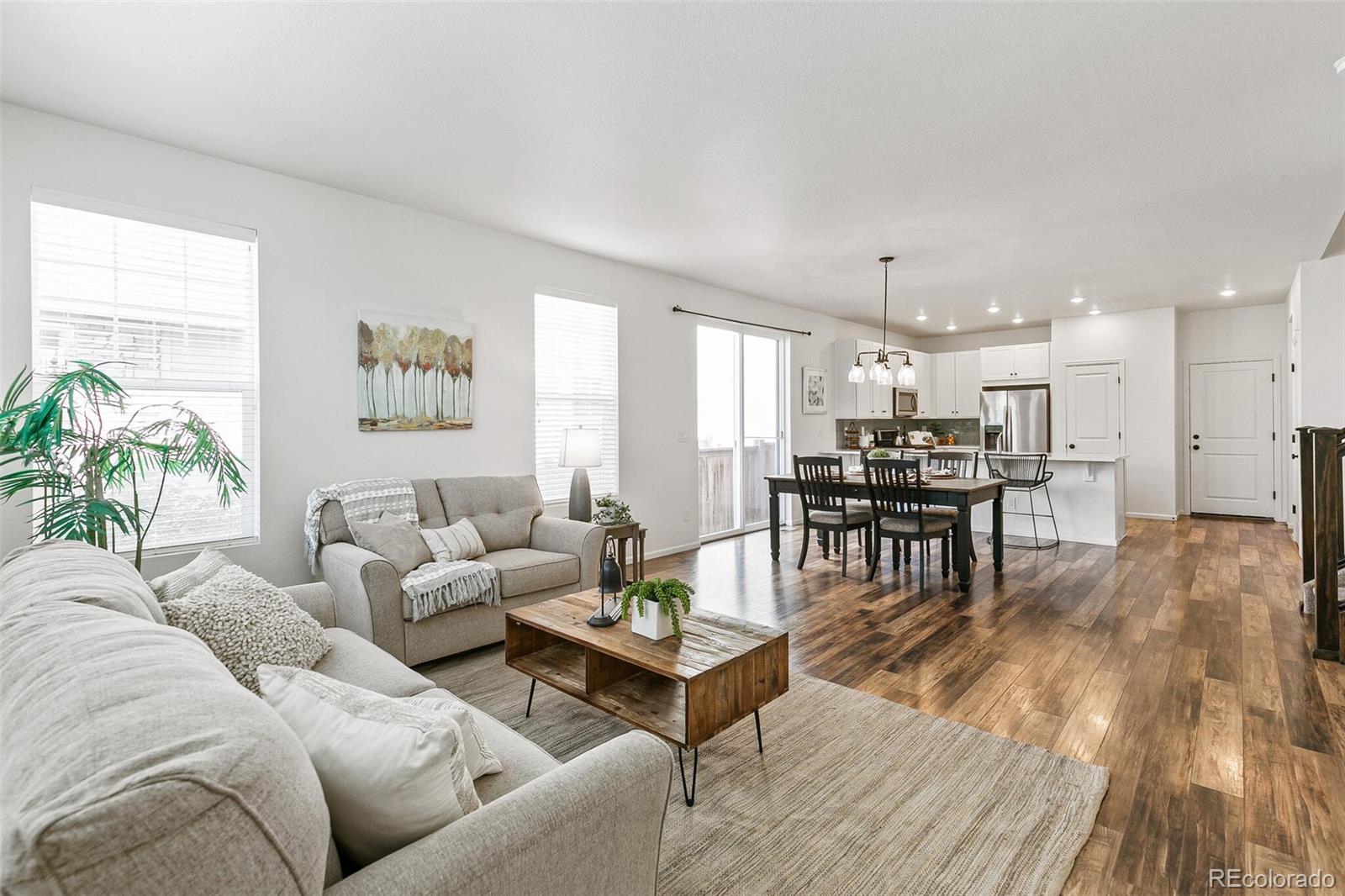 11159 East 25th Drive Aurora, CO 80010 - Photo 2 of 23 a living room with furniture and kitchen view
